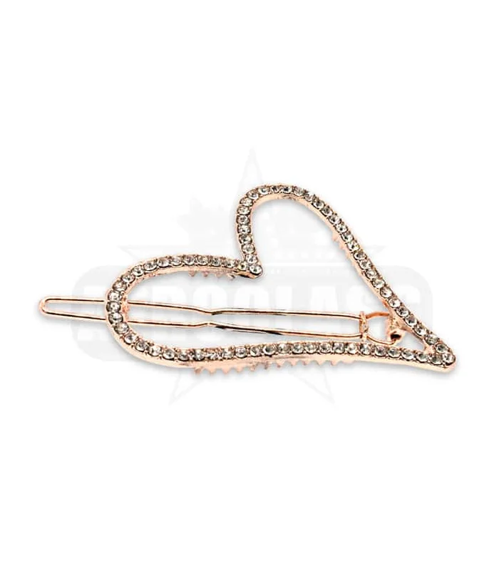 Barrette pour cheveux en métal et motif cœur en strass.